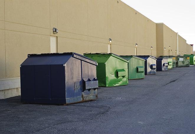 a row of construction dumpsters parked on a jobsite in Bell, CA